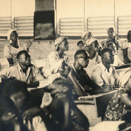 men and women listening, in a classroom setting
